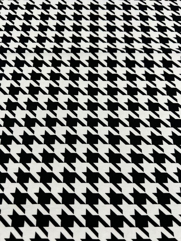 The Printed Bengaline - Grande Houndstooth from Super Cheap Fabrics is a black and white houndstooth pattern with jagged angular shapes. With its medium weight and two-way stretch, it offers comfort and improved fit, spanning 150cm wide.