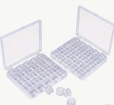 Two Super Cheap Fabrics "Bobbins With Case 25" storage cases, featuring rows of small round compartments filled with clear coin holders and empty bobbins. A few coin holders and bobbins are placed outside on a white surface.