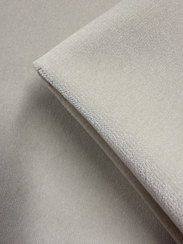 A close-up of two pieces of Super Cheap Fabrics' Oxford Velvet - Warm Snow (144cm), light beige with a suede-like, soft, and subtly textured surface, layered together.