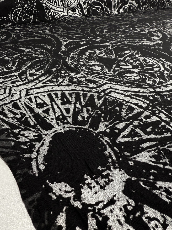 Close-up of Super Cheap Fabrics' Viscose Knit - Fossil (142cm), featuring medium weight fabric with metallic silver abstract geometric and organic patterns for a textured, artistic surface.