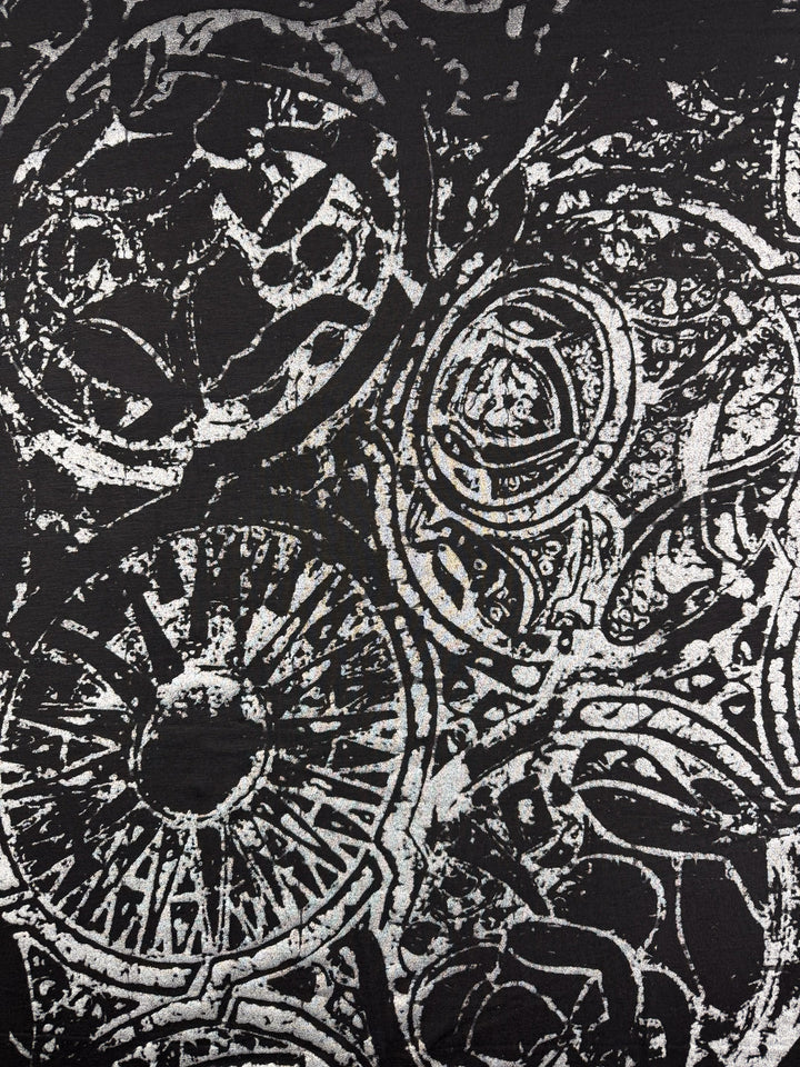 Abstract black and white artwork with intricate circular and spiral designs inspired by the layered textures of Super Cheap Fabrics' Viscose Knit - Fossil - 142cm, featuring varied line thicknesses for a complex, dynamic look.