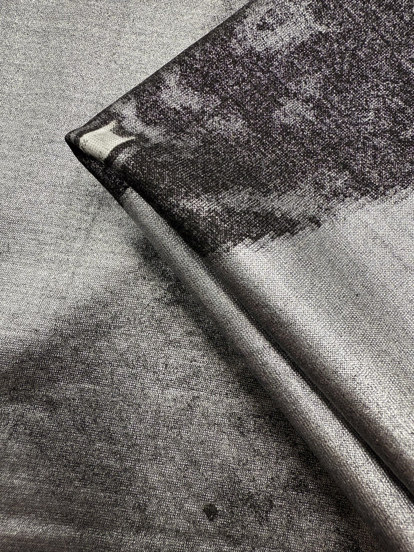 Close-up of Super Cheap Fabrics' Viscose Knit - Cosmic Burst (145cm), a silver and black stretch viscose with a subtle abstract pattern, shiny metallic look, smooth finish, and breathable—perfect for summer projects.