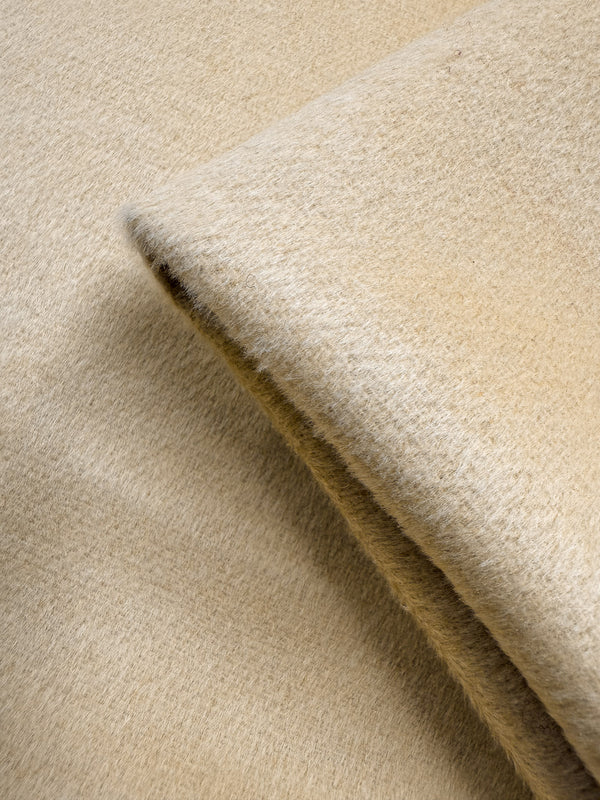 Close-up of Super Cheap Fabrics' Wool Cashmere - Sahara Sun (150cm), showcasing its soft, extra heavy weight beige material with a fuzzy, luxurious texture.