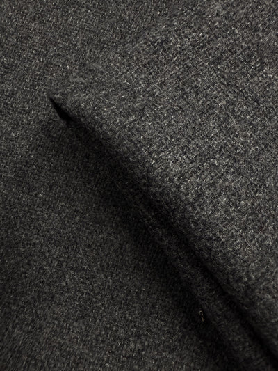 Close-up of Super Cheap Fabrics' Hopsack Wool in Charcoal (150cm), highlighting its coarse, textured weave and soft, slightly fuzzy surface.