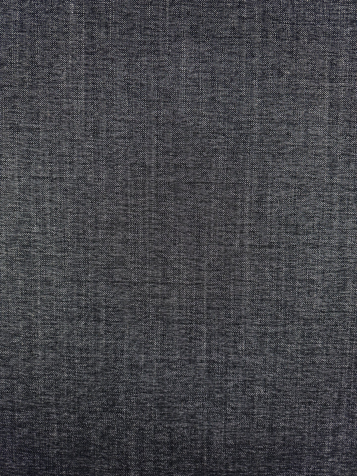 Close-up of Super Cheap Fabrics' Upholstery Tweed - Dresden Charcoal (146cm): a dark gray woven textile with fine, interlaced threads and a subtle grid pattern, perfect for upholstery with its slightly mottled, evenly lit surface.