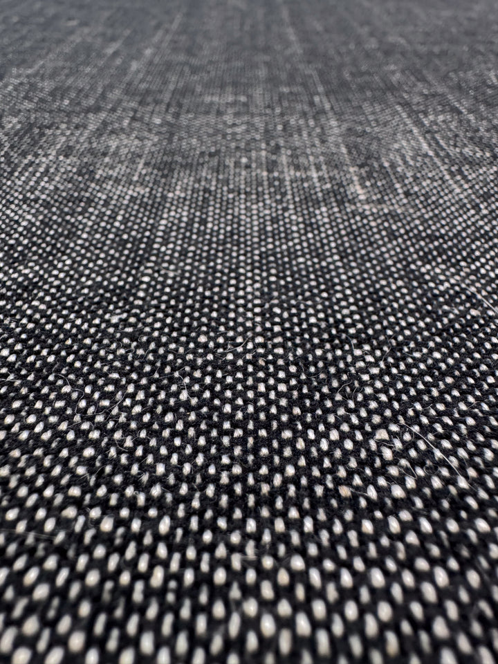 Close-up of Upholstery Tweed - Dresden Charcoal (146cm) by Super Cheap Fabrics, featuring a textured black and white grid pattern with small white dots—ideal for high-end upholstery projects.