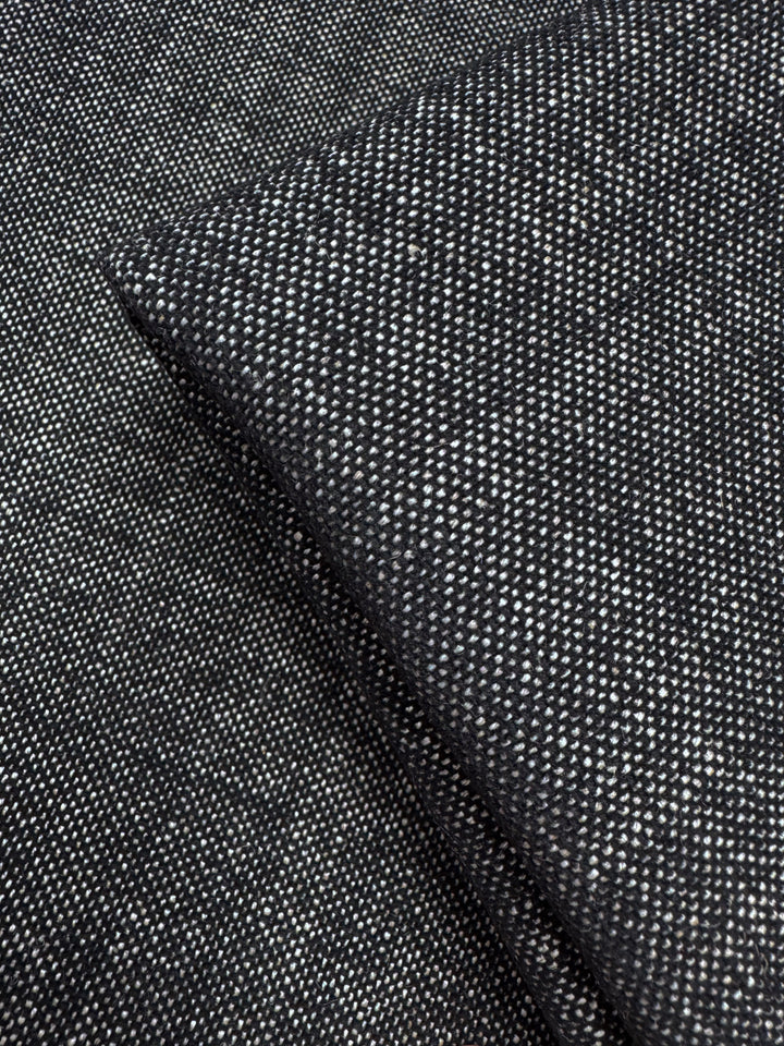Close-up of Upholstery Tweed - Dresden Charcoal (146cm) by Super Cheap Fabrics, showing its dark gray, finely speckled weave and thick texture—premium upholstery fabric from an Australian wholesaler.