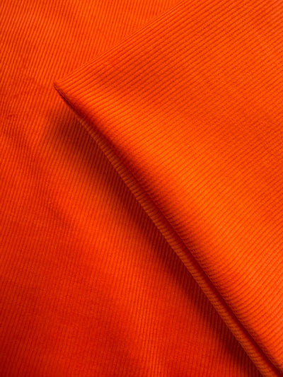 Close-up of Super Cheap Fabrics' Pin Wale Corduroy - Fiesta (142cm), showcasing its soft texture and parallel ridges—perfect for cozy winter wear.