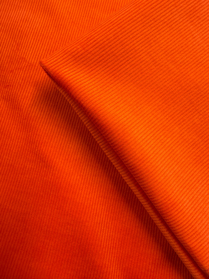 Close-up of Super Cheap Fabrics' Pin Wale Corduroy - Fiesta (142cm), showcasing its soft texture and parallel ridges—perfect for cozy winter wear.