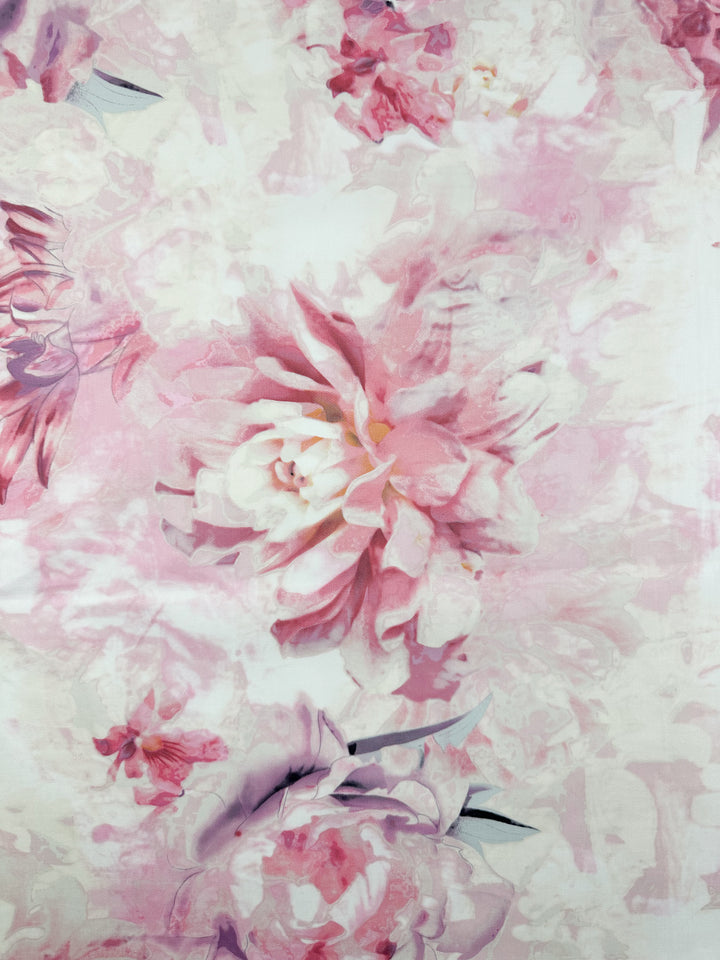 The "Cotton Sateen - Mystic Garden - 125cm" by Super Cheap Fabrics showcases large pink and white peonies on a soft, abstract background, perfect for household décor.
