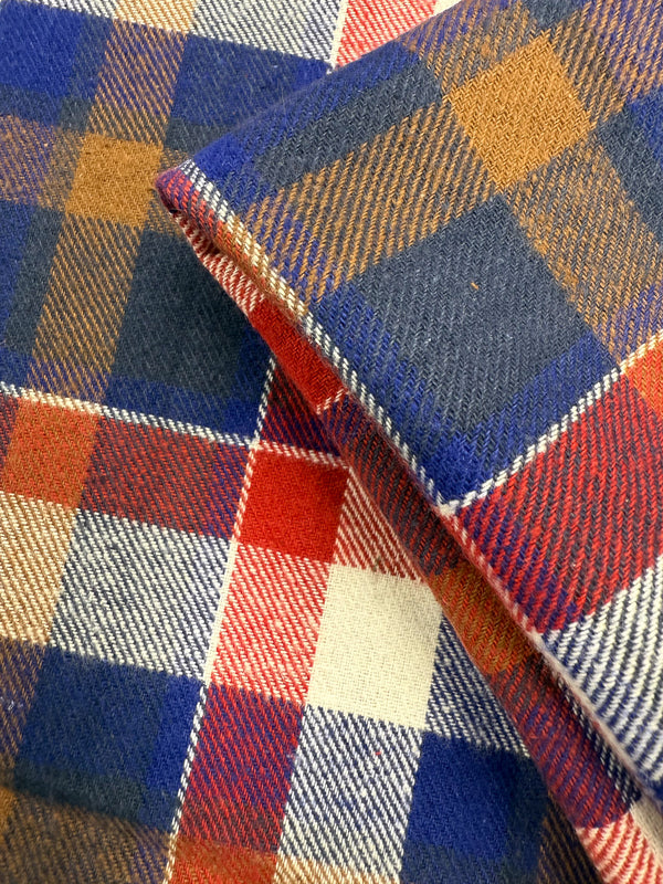 Close-up of Super Cheap Fabrics’ Flannel Plaid - Autumn Rust Check (145cm) shows its blue, red, white, and brown intersecting lines and squares for a classic plaid look with a soft, textured cotton weave.