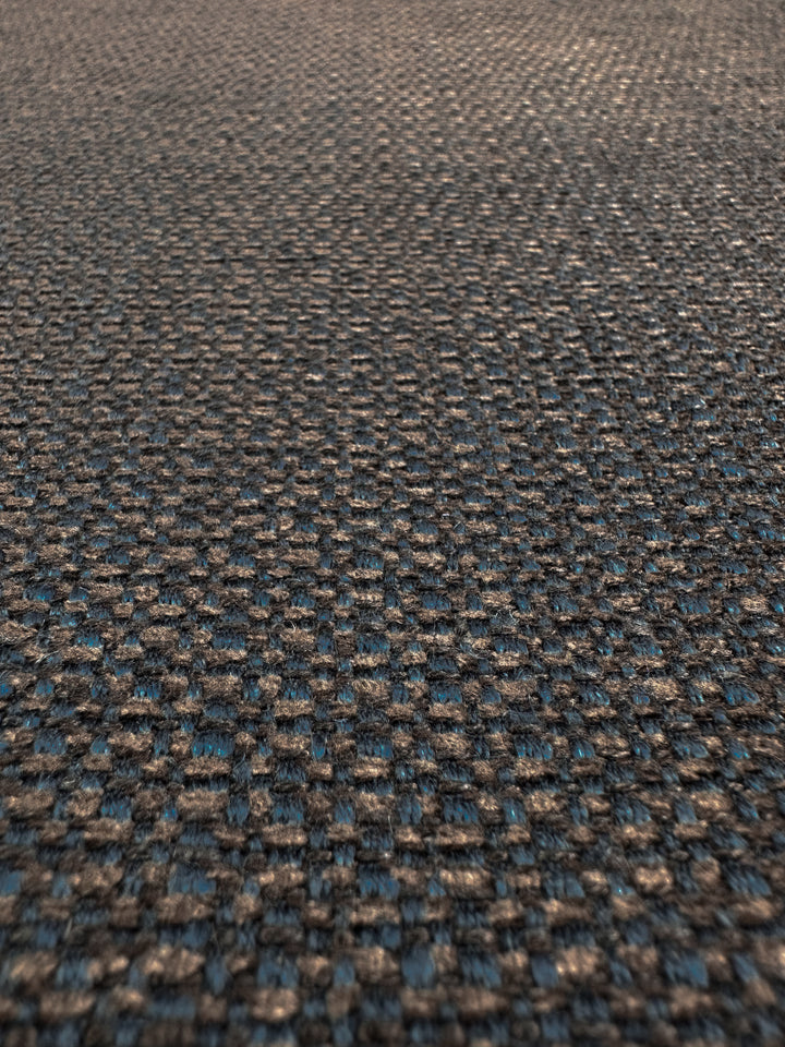 Close-up of Super Cheap Fabrics' Basket Weave Upholstery - Tuco 035 - 147cm, featuring a grid-like coarse woven pattern in gray and blue shades. This heavy weight fabric's smooth, slightly reflective surface highlights its high durability.