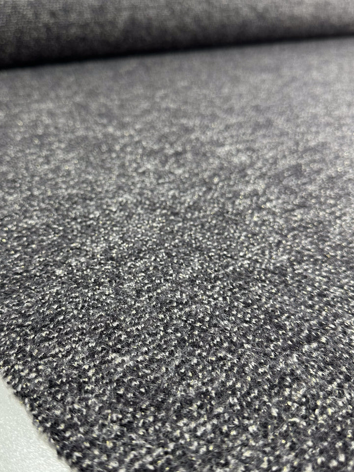 Close-up of Super Cheap Fabrics' Boiled Wool - Lamé Charcoal Marle (150cm), highlighting its soft, speckled texture and elaborate weave. The fabric is spread flat for a smooth, even appearance across the image.