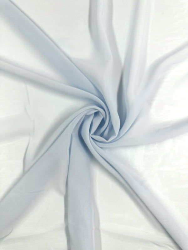 The Hi-Multi Chiffon - Skywriting - 150cm by Super Cheap Fabrics features a soft, light blue polyester fabric exquisitely gathered at the center to form a spiral pattern, with its lightweight and smooth texture creating delicate, outward radiating folds.