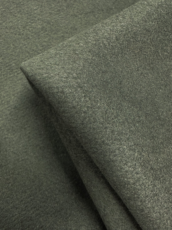 Close-up of overlapping pieces of Super Cheap Fabrics' Wool Cashmere in Agave Green (150cm), highlighting its luxurious softness and smooth, slightly fuzzy texture.