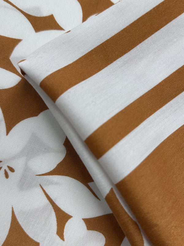 Designer Rayon - Clay Fade from Super Cheap Fabrics features smooth, neatly arranged fabric with a chic white and brown pattern, perfect for stylish and vibrant projects. Width: 145cm.