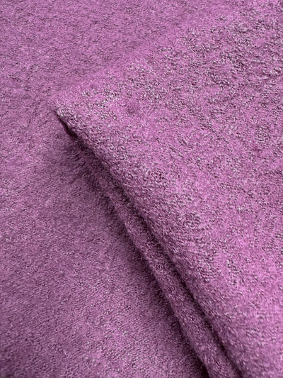 A close-up of Boiled Wool - Mauve Orchid (142cm) from Super Cheap Fabrics shows its textured, soft, and slightly fuzzy surface—this medium to heavy weight wool is perfect for cozy garments.