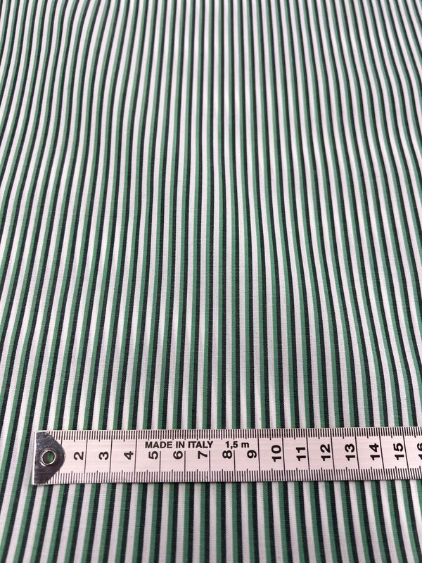 The Shirting - Lizard - 150cm by Super Cheap Fabrics is a lightweight, green and white vertically striped polyester cotton fabric, shown with a metal measuring tape in centimeters at the bottom.