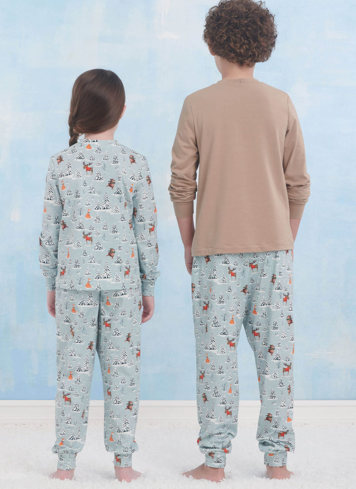 Two children wearing the "Pattern - Simplicity - S9861" knit loungewear by Super Cheap Fabrics stand back-to-back in matching colorful pajamas against a soft, light blue background.